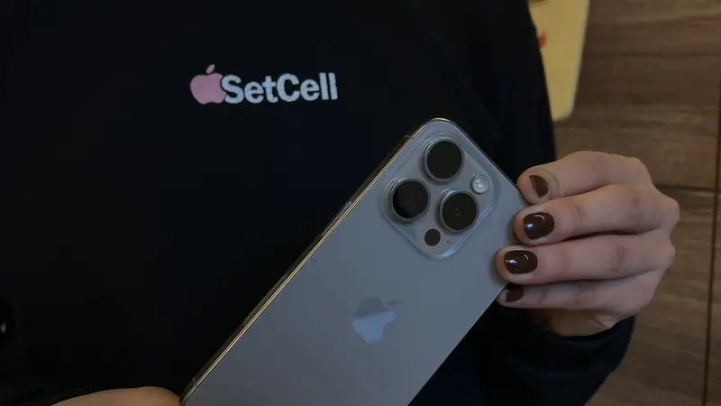 Persona con remera de SetCell sosteniendo un iPhone 15 Pro